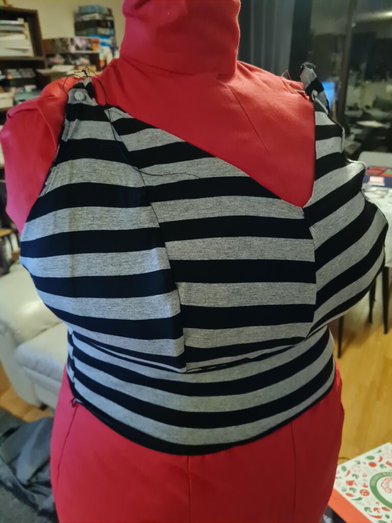 Red plus-size dress form in a black and grey bralette